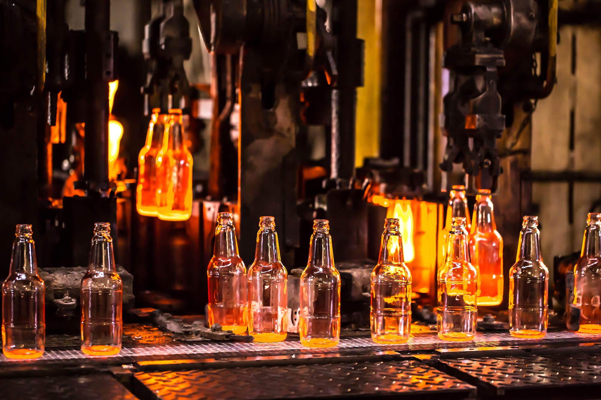 Glass bottles being manufactured in a furnace.