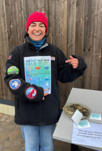 Smiling woman holding a poster. 