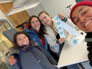 Four happy women, one holding stickers